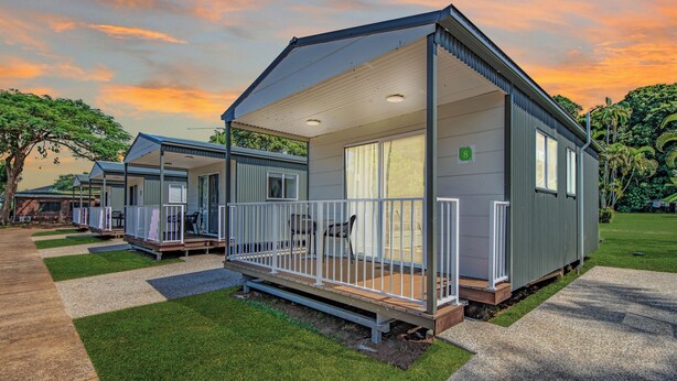 A row of modern, single-story mobile homes with a covered porch and a small deck area. - Hideaway Mission Beach Village (Mission Beach)