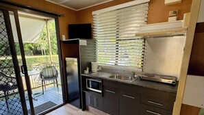 A compact kitchen with a microwave, stove, and sink. - Hideaway Mission Beach Village (Mission Beach)