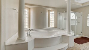 A modern bathroom with a freestanding bathtub, a glass shower enclosure, and a large window providing natural light. - Close to Airport, Stadium, and Strip. Villa with Amazing Pool and BBQ/Bar Area (Las Vegas)