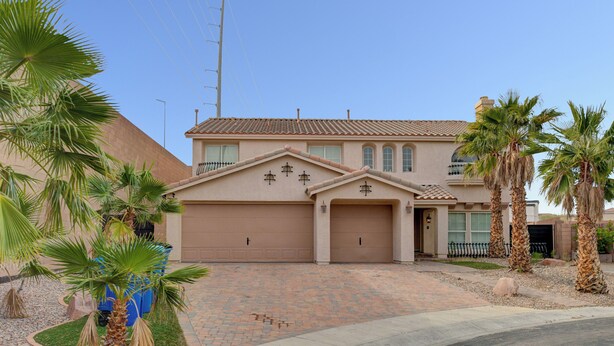 A two-story house with a garage, palm trees, and a paved driveway. - Close to Airport, Stadium, and Strip. Villa with Amazing Pool and BBQ/Bar Area (Las Vegas)