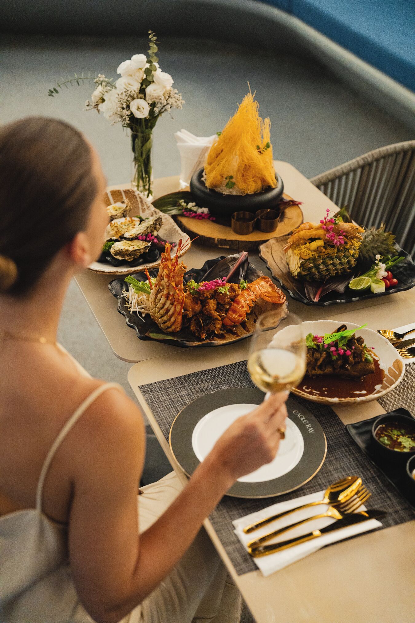 A dining table with various dishes, including seafood and a centerpiece.