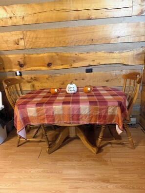 A wooden table with a plaid tablecloth, two orange mugs, and a white pumpkin-shaped container with 'Give thanks' written on it. - Cozy cabin in lovely Seneca Rocks WV with WiFi, smart TVs and jucuzzi tub  (Seneca Rocks)