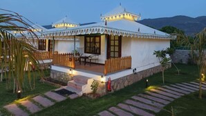 A traditional-style building with a covered porch and a stone foundation. - Arvana Resort & Spa Pushkar (Pushkar)