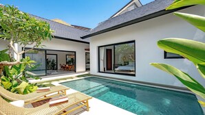 A modern house with a swimming pool, large windows, and outdoor furniture. - Casa Umari (Canggu)