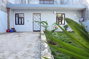 Stylish building with a flat roof and clean lines, featuring two entrance doors with glass panels.