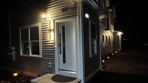 A house with a front door, a small porch, and a number '70' sign. - Family Vacation Modern Norwood  (Norwood)