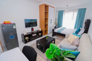 Deluxe Studio Suite, City View | Living area | 24-inch Smart TV with digital channels