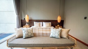 A spacious, modern bedroom with a large bed, two bedside tables, and a view of a pool. - Damarya Villa Canggu (Canggu)