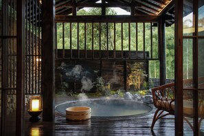 A traditional wooden structure with a hot spring, a wooden bench, and a lantern. - ChillMont (Huzhou)