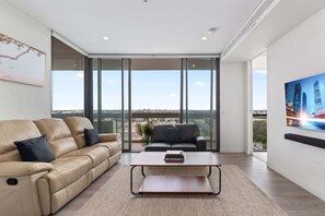 TV, offices - Luxe 2-Bed: Modern Interiors, Balcony & BBQ Area (Lidcombe)