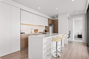 Fridge, microwave, oven, stovetop - Luxe 2-Bed: Modern Interiors, Balcony & BBQ Area (Lidcombe)