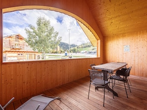 Enjoy a peaceful view of the surrounding countryside from this room's large arched window.