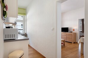 A modern kitchen with a built-in microwave, a sink, and a window.