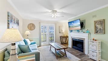Signature Condo, 2 Bedrooms, Balcony, Garden View | Living room | 55-inch Smart TV with cable channels, fireplace