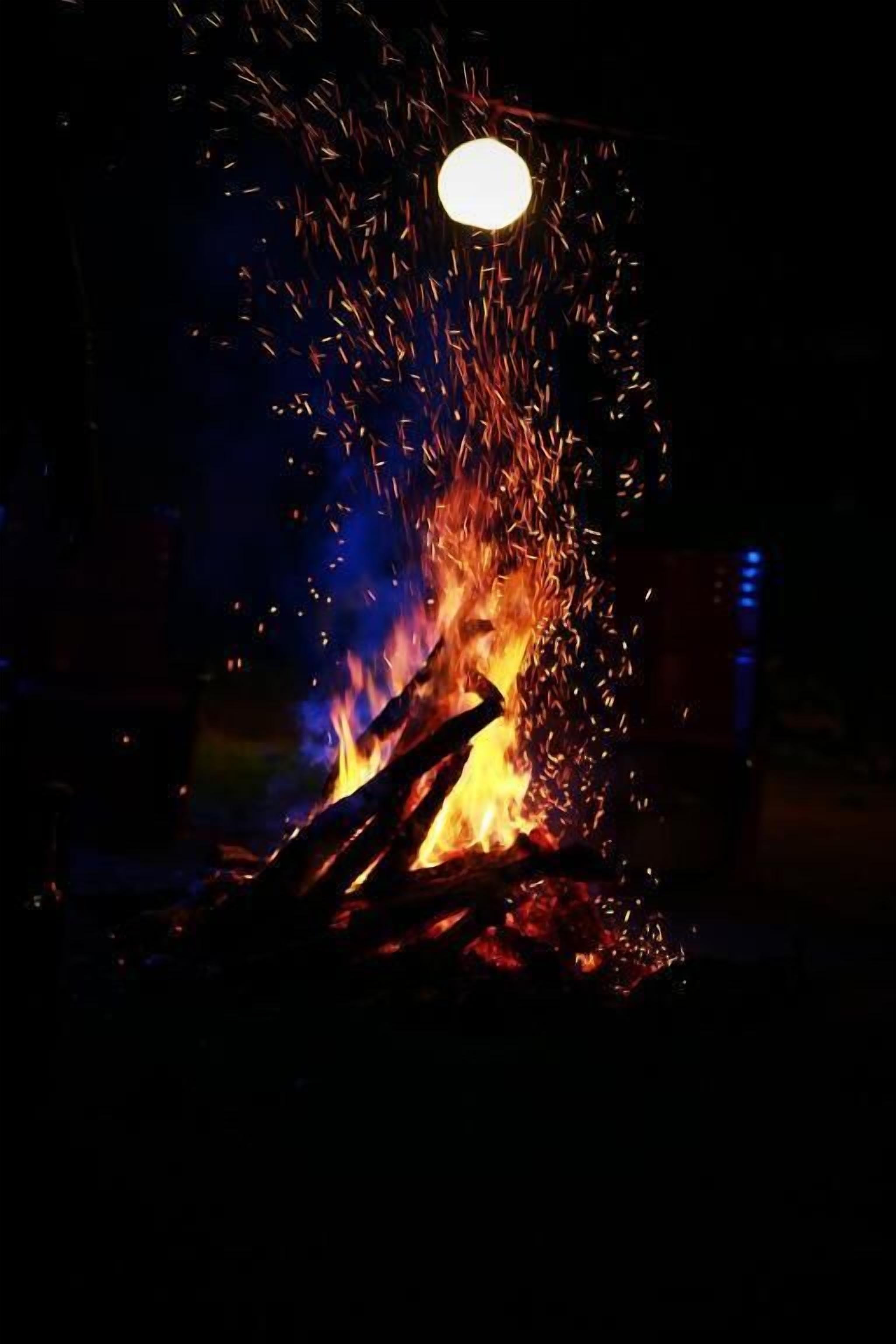 A campfire with visible flames and sparks.