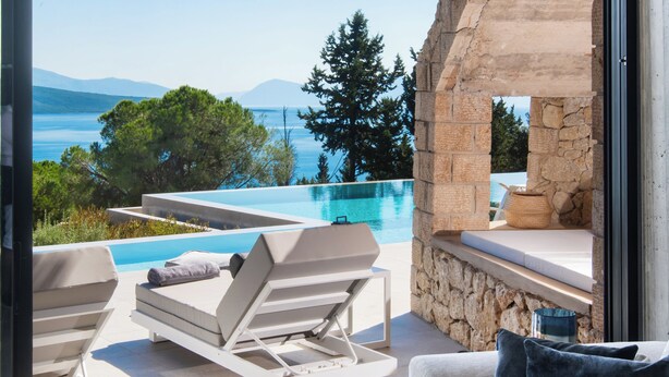 A modern living room with a view of a swimming pool and mountains. - Ionian Grand Villas - Villa Naya (QPM9+9JR, Lefkada)