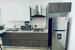 Fridge, microwave, stovetop, coffee/tea maker