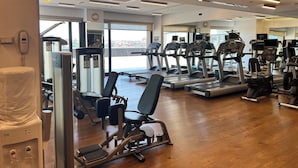 A gym with treadmills, weight machines, and a water dispenser. - Akmerkez Residence (Istanbul)