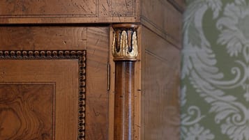 A wooden cabinet with intricate carvings and a decorative top.