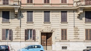 Un immeuble à plusieurs étages, de style architectural classique, caractérisé par des fenêtres et des balcons disposés de manière symétrique.