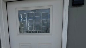 A white door with a small window and a keyhole. - Studio  apartment w/balcony-Nob Hill, UNMH, Pres Hosp. (Albuquerque)