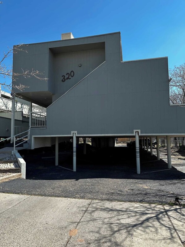 A modern building with a flat roof and a large number '320' on its side.