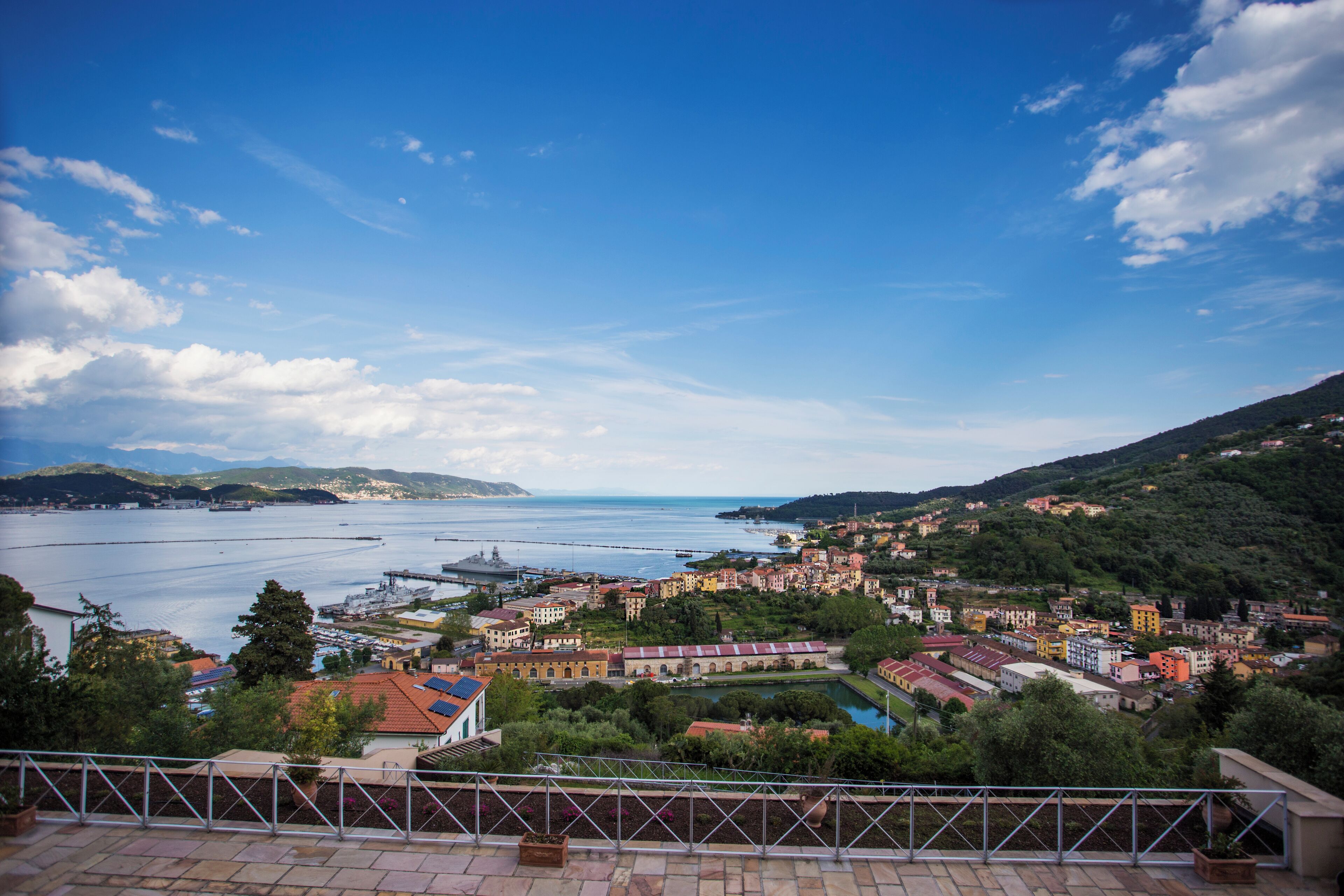 A coastal town with buildings, a harbor, and a clear sky.