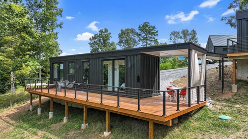 Luxury 1BR container home in North Georgia with a private deck, fire pit, and hammock. Pet-friendly and perfect for a relaxing getaway.
