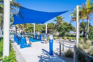 Work out in a serene outdoor space surrounded by lush greenery and shaded by a canopy.