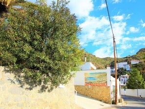 Residential area with a scenic mural and lush greenery.