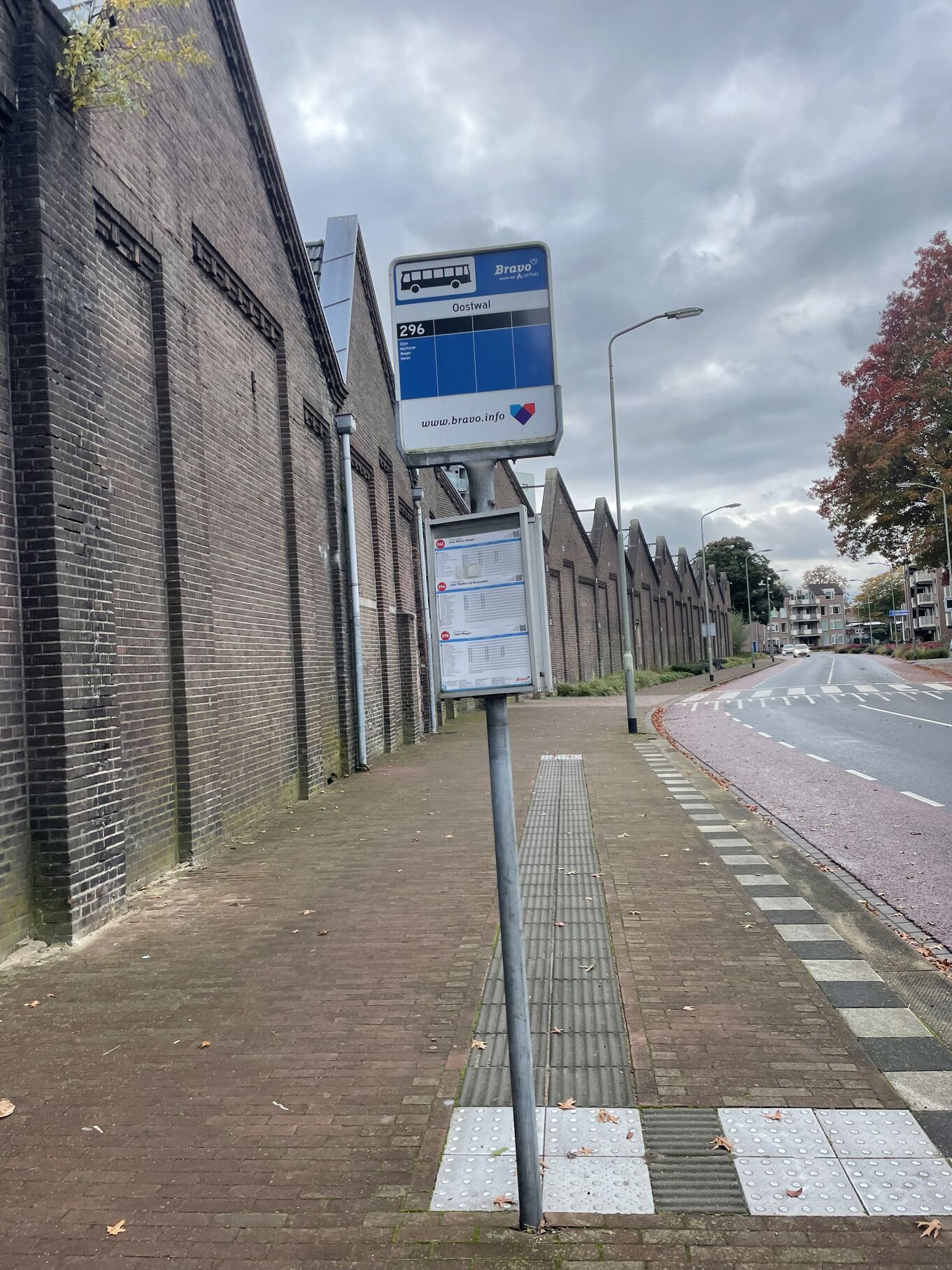 A bus stop sign with the number 296 and a website link.