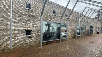 A brick building with large windows and metal frames.