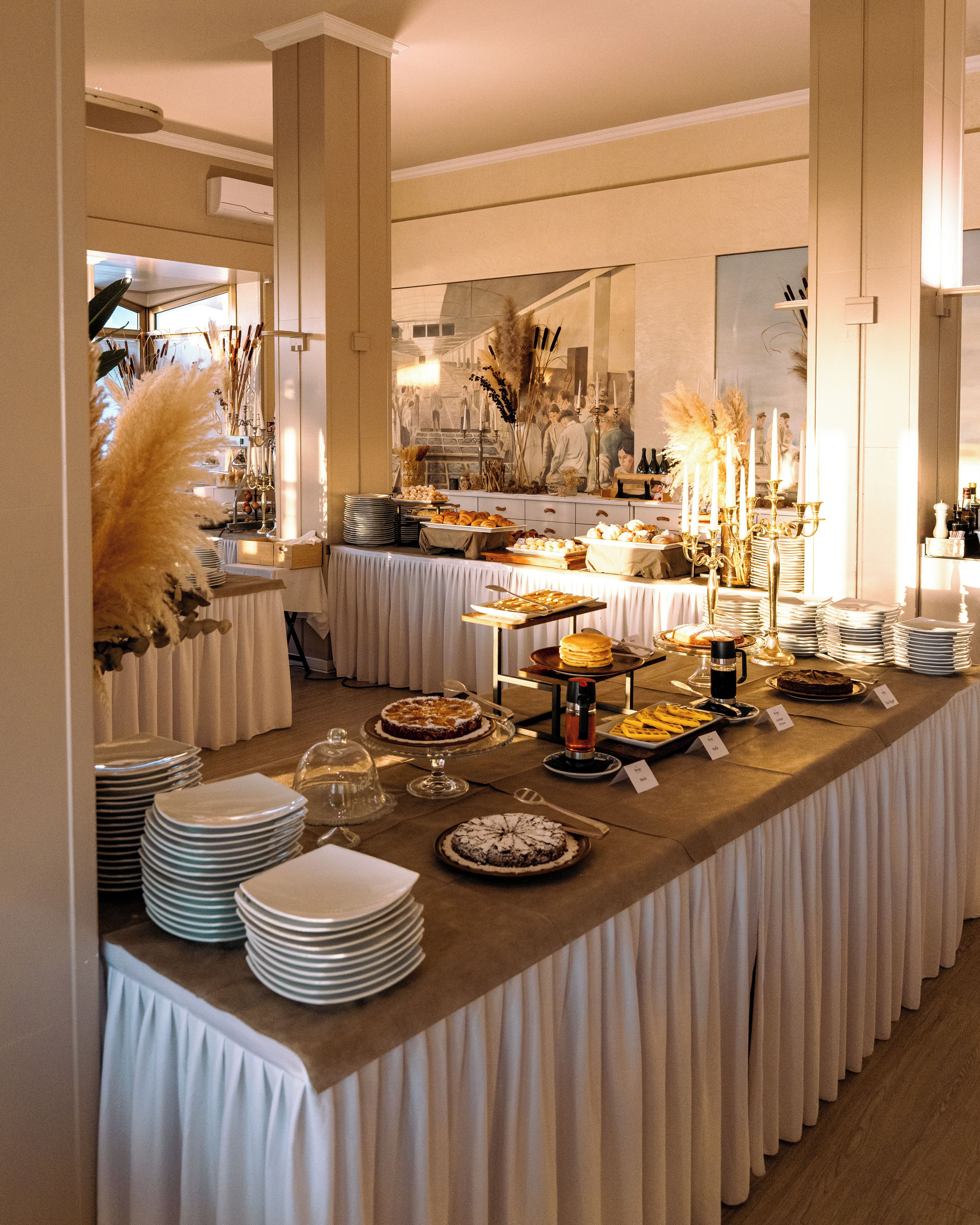 A buffet setup with various food items and a decorative centerpiece.