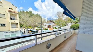 A balcony with a view of a street, a building labeled 'VITALDENT', and a clear sky. - Cozy holiday apt Marbella center. (Marbella)