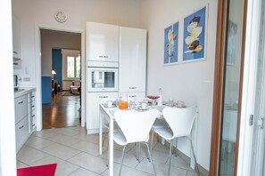 Enjoy meals in this stylish kitchen and dining area, featuring an oven, microwave, and seating for two.