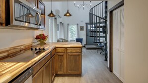 A modern kitchen with wooden cabinets, a built-in microwave, and pendant lighting. - Mtn-view Gem w/ Grill: 2 Mi to Dtwn Livingston (Livingston)