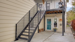 A building with a metal staircase leading to a second-floor balcony. - Mtn-view Gem w/ Grill: 2 Mi to Dtwn Livingston (Livingston)