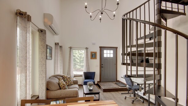 A spacious living area with a staircase, a sofa, a coffee table, and a chair. - Mtn-view Gem w/ Grill: 2 Mi to Dtwn Livingston (Livingston)