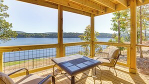 A wooden deck with a table and chairs, overlooking a lake with hills in the background. - Decks & Boat Dock: 'the View on Lay Lake!' (Shelby)