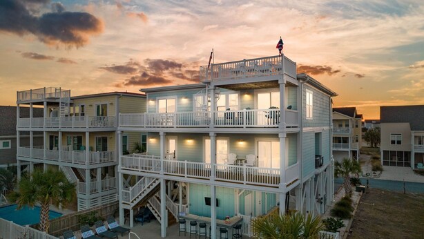 A multi-story building with balconies, a pool, and a flag. - Easy Breezy is a 4 bedroom, 5 bathroom house w/ private pool & elevator (Sunset Beach)