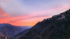 A mountainous landscape with a sunset. - Royal Cedar Shimla (Shimla)