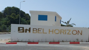 A sign for 'BEL HORIZON' with a modern building in the background. - 123 Sun and Relaxation (Tabarka)