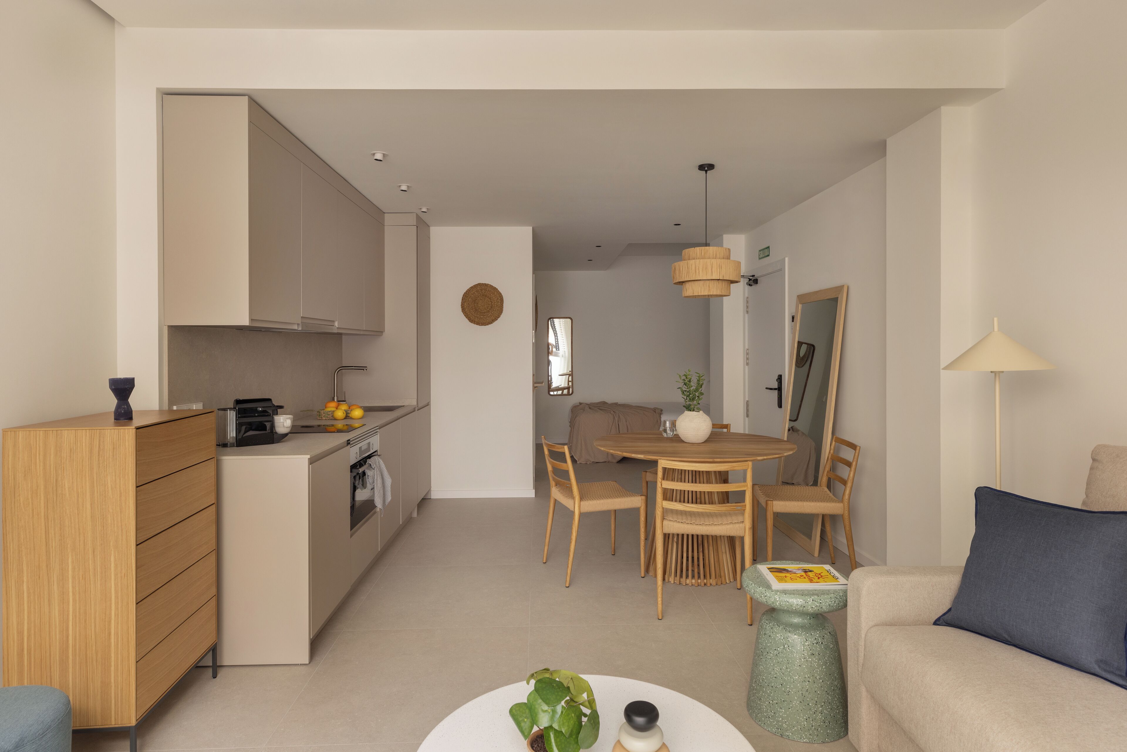 A modern apartment with a kitchen, dining area, and living room.