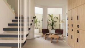 Ein modernes Interieur mit Treppe, Sitzgelegenheit und Schließfächern.