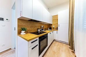 Family Apartment, 1 Bedroom, Courtyard View | Private kitchen | Full-sized fridge, microwave, oven, stovetop - MamaStay Andel apartments (Prague)