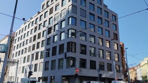 A modern multi-story building with a grid of windows and balconies. - MamaStay Andel apartments (Prague)