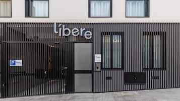 Libere's sleek entrance welcomes guests with a modern design and ample parking.