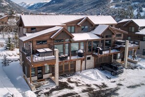 Enjoy the expansive views from the second-floor balcony of this lodge, featuring large windows and a garage.
