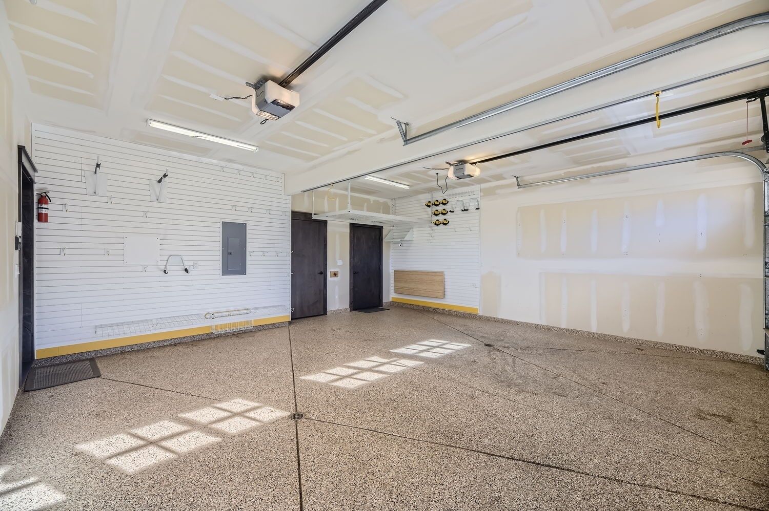 A spacious, well-lit indoor area with a high ceiling, large windows allowing natural light, and a clean, polished floor.