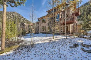 Relax on the covered porch amidst the serene mountain landscape.